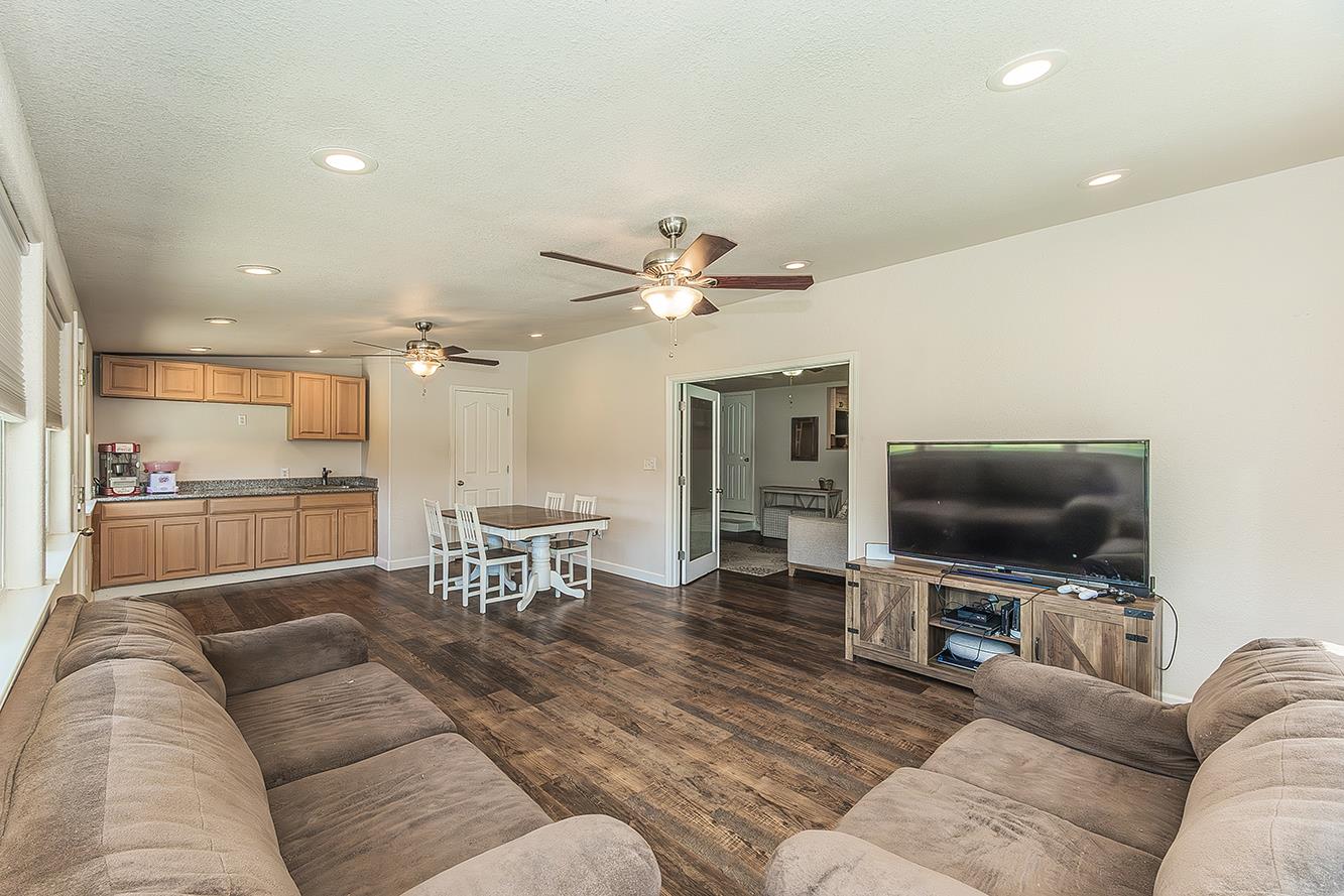 1563 South Klein Avenue Reedley, CA 93654 - Photo 17 of 81 a living room with furniture and a flat screen tv