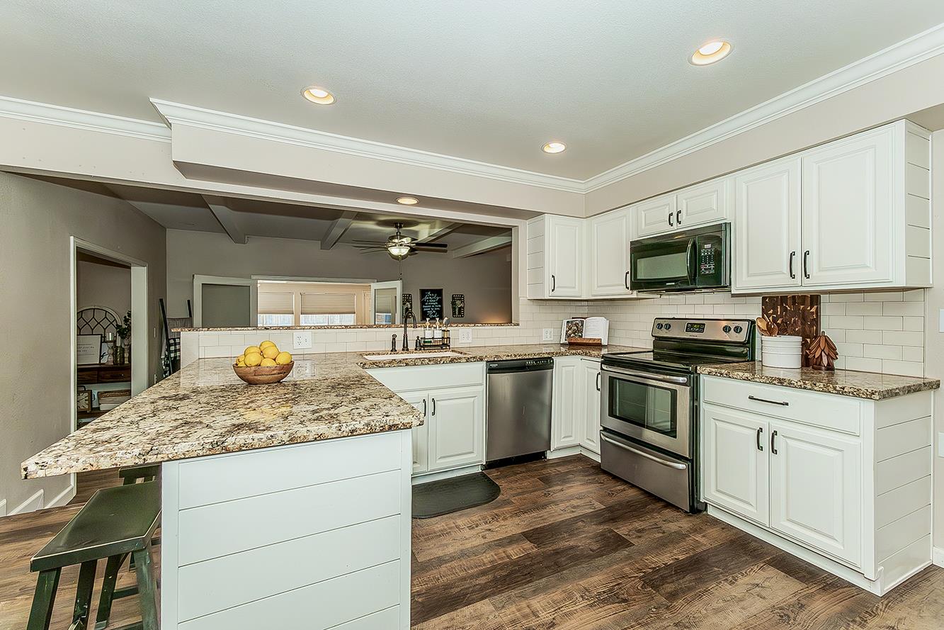 1563 South Klein Avenue Reedley, CA 93654 - Photo 26 of 81 a kitchen with a sink stove and microwave
