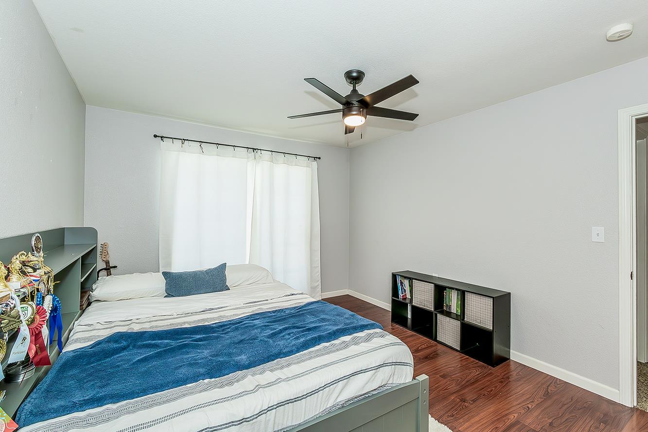 1563 South Klein Avenue Reedley, CA 93654 - Photo 37 of 81 a bedroom with a bed and a chandelier