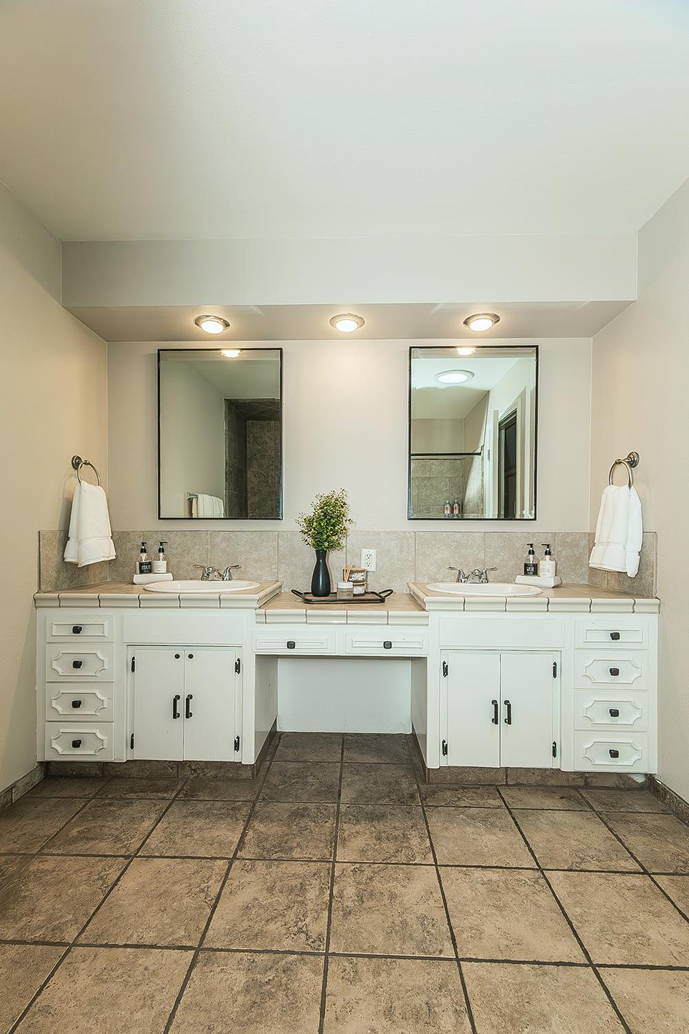 1563 South Klein Avenue Reedley, CA 93654 - Photo 39 of 81 a bathroom with a sink vanity and mirror