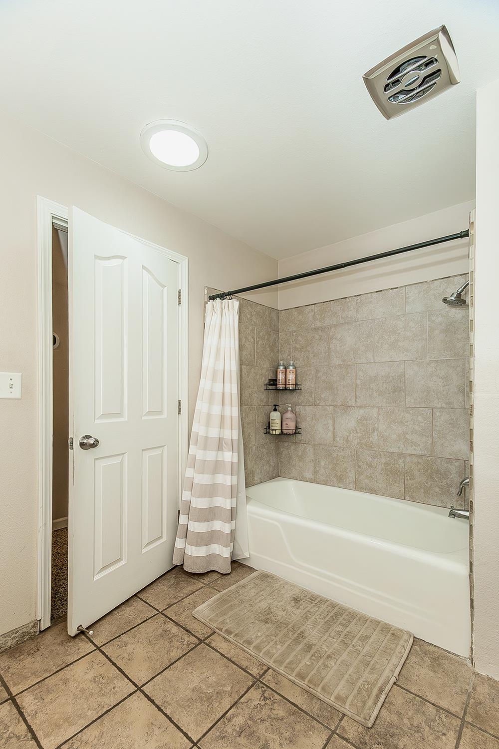 1563 South Klein Avenue Reedley, CA 93654 - Photo 40 of 81 a bathroom with a shower and a bath tub