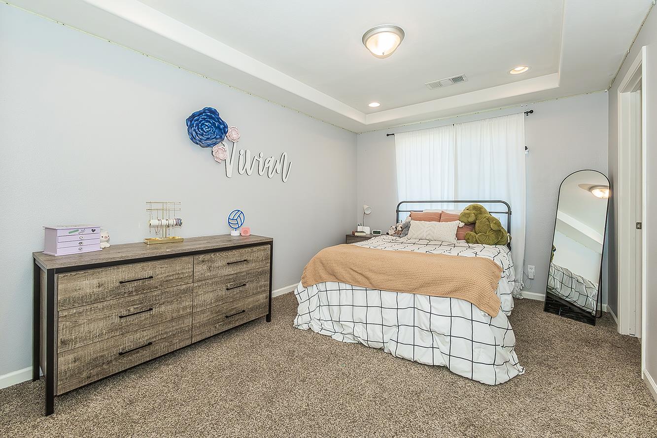 1563 South Klein Avenue Reedley, CA 93654 - Photo 48 of 81 a bedroom with a bed and a chandelier