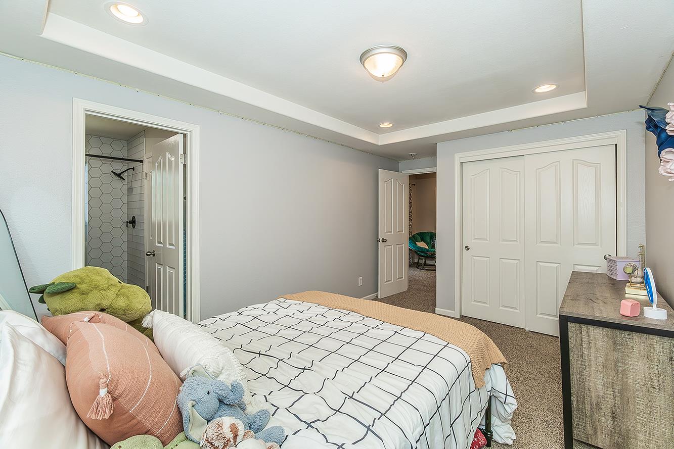 1563 South Klein Avenue Reedley, CA 93654 - Photo 50 of 81 a bedroom with a bed and a lamp
