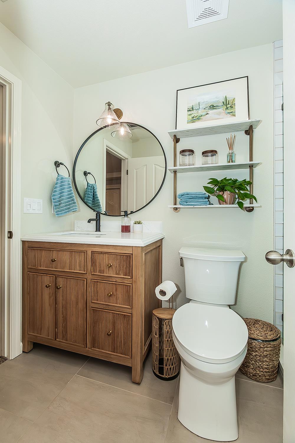 1563 South Klein Avenue Reedley, CA 93654 - Photo 52 of 81 a bathroom with a toilet a sink and wooden floor