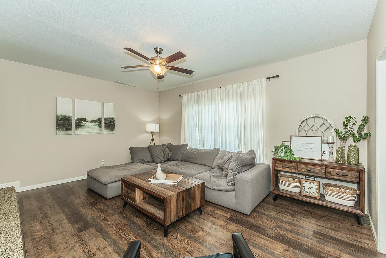 1563 South Klein Avenue Reedley, CA 93654 - Photo 6 of 81 a living room with furniture a chandelier and a window