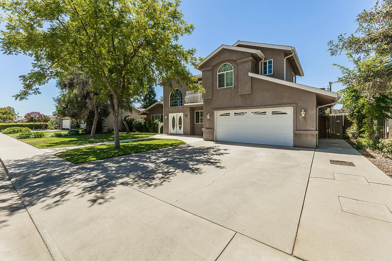 1563 South Klein Avenue Reedley, CA 93654 - Photo 67 of 81 a front view of a house with a yard and garage