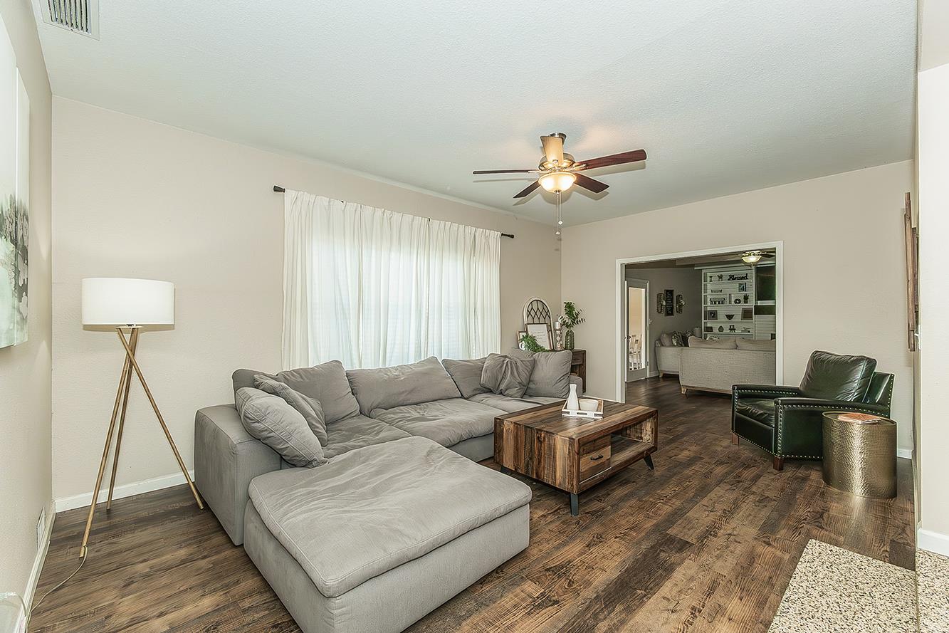 1563 South Klein Avenue Reedley, CA 93654 - Photo 9 of 81 a living room with couches and a potted plant on a dresser