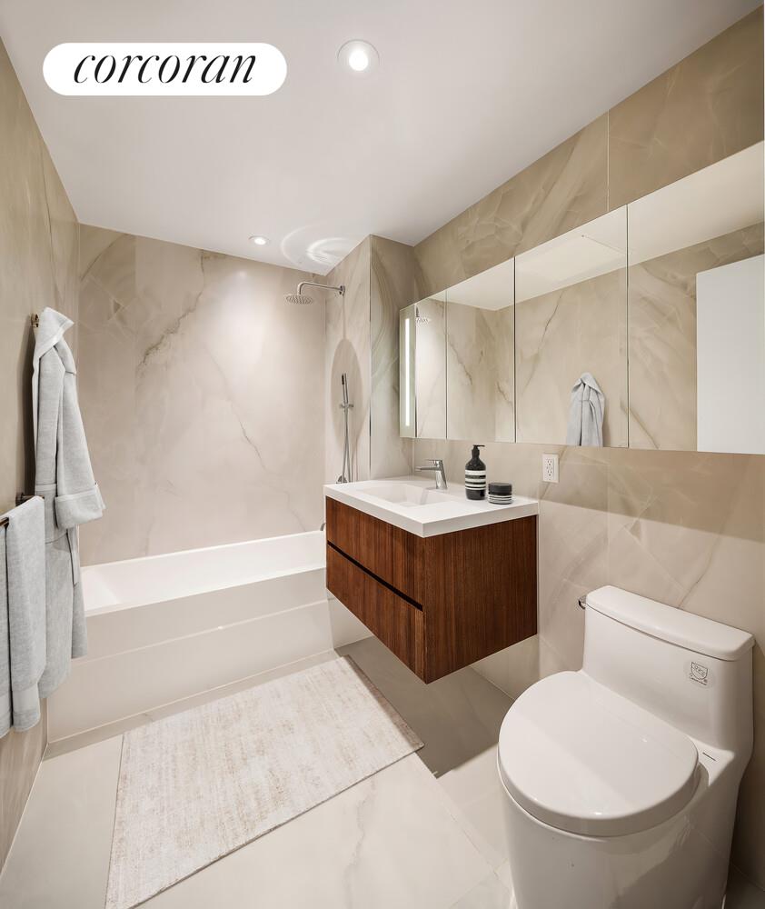 355 West 39th Street, Unit 7B Manhattan, NY 10018 - Photo 5 of 9 a bathroom with a tub a sink and a toilet