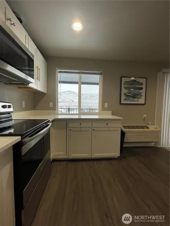 a kitchen with stainless steel appliances a stove a sink and a microwave