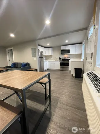 a kitchen with stainless steel appliances granite countertop a stove top oven a sink a counter space and cabinets