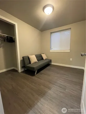 a living room with furniture and a air conditioner vent
