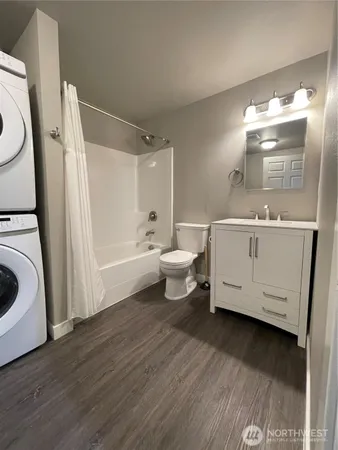a bathroom with a sink a toilet and bathtub