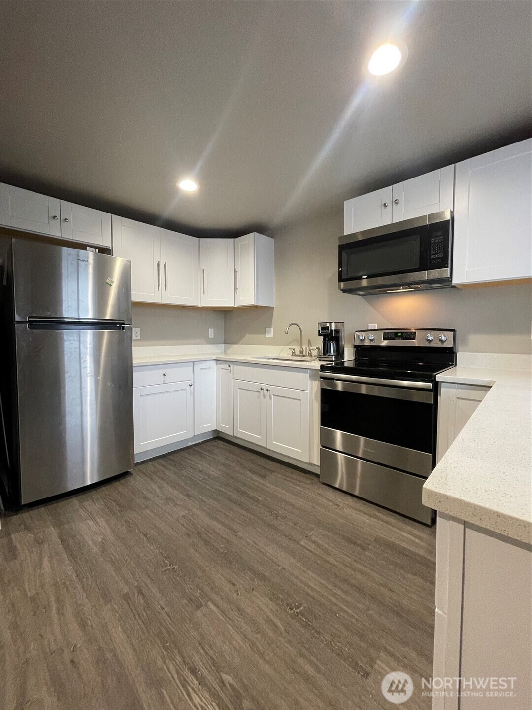 59 Elmer City Access Road Coulee Dam, WA 99116 - Photo 32 of 39 a kitchen with stainless steel appliances a refrigerator stove and white cabinets