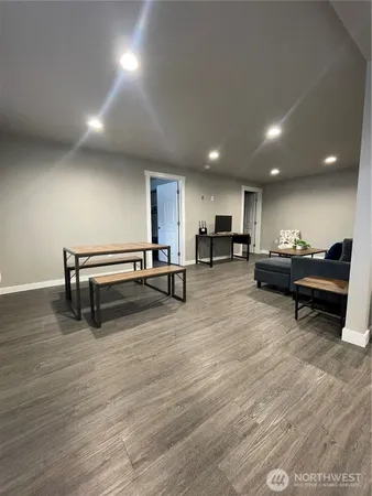 a living room with furniture and a wooden floor