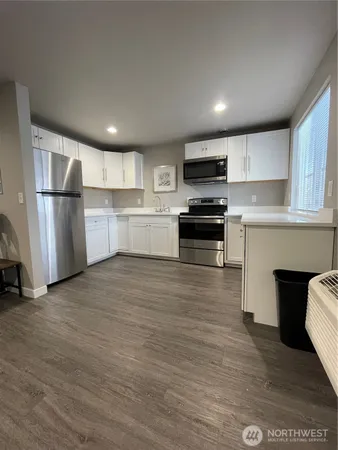 a kitchen with a refrigerator and a stove top oven