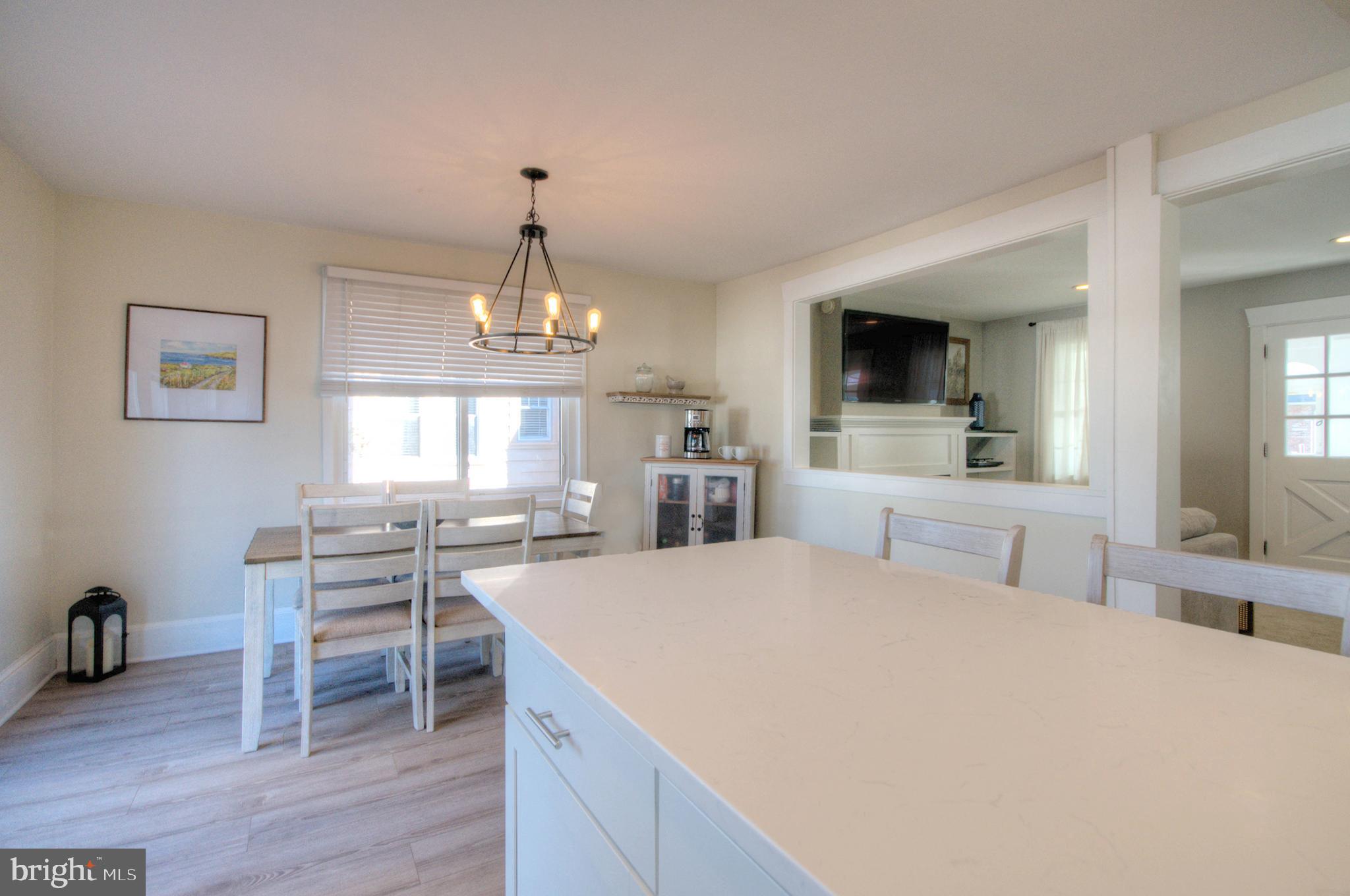 23 East Holly Haddon Township, NJ 08107 - Photo 17 of 35 a large open kitchen with a table chairs wooden floor and a fireplace