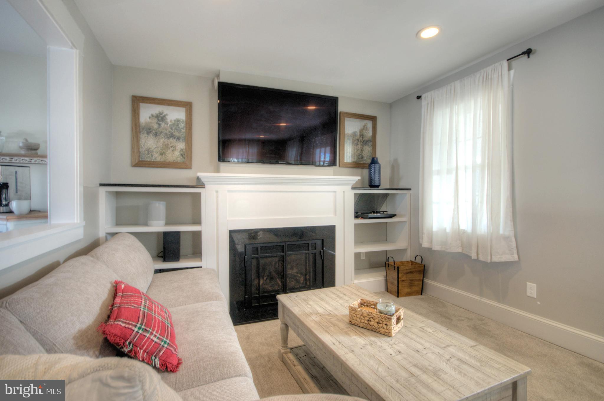 23 East Holly Haddon Township, NJ 08107 - Photo 8 of 35 a living room with furniture a flat screen tv and a fireplace