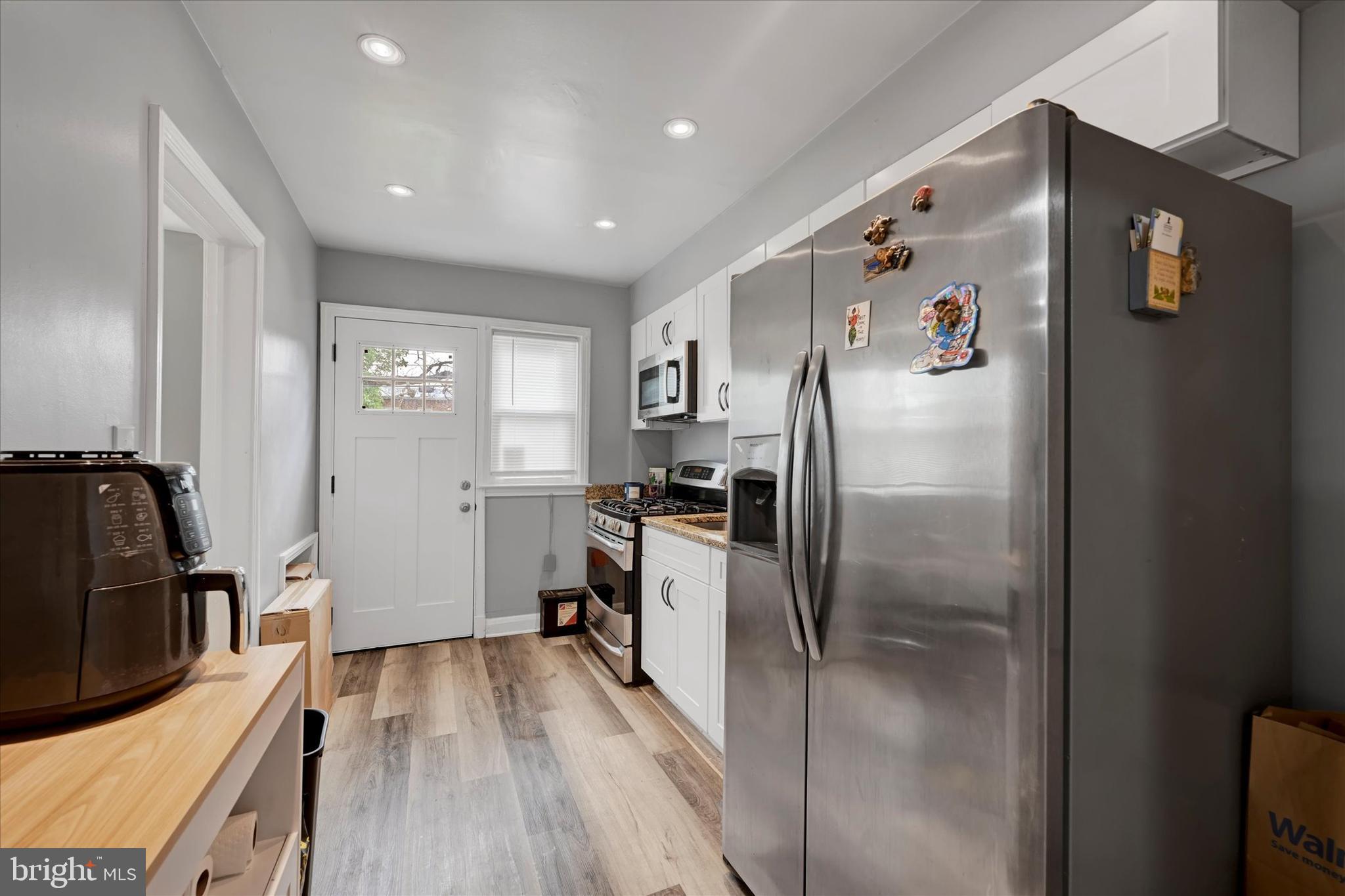 825 Wicklow Road Baltimore, MD 21229 - Photo 8 of 15 a kitchen with stainless steel appliances granite countertop a refrigerator and a stove top oven