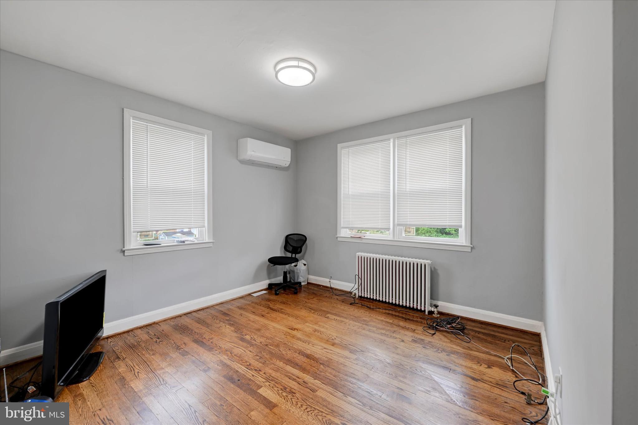 825 Wicklow Road Baltimore, MD 21229 - Photo 10 of 15 a bedroom with a bed and a window