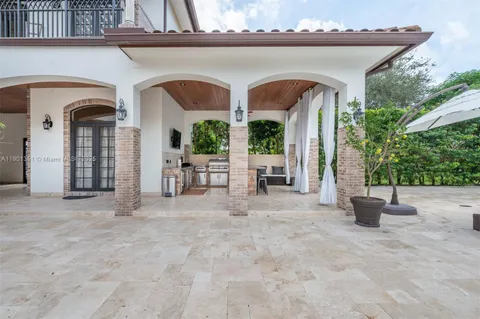 an entrance to house with yard and outdoor seating