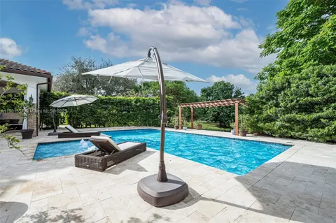 swimming pool view with a seating space
