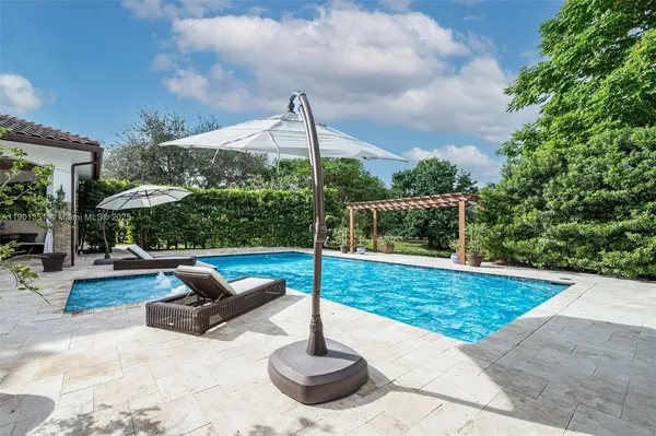 swimming pool view with a seating space