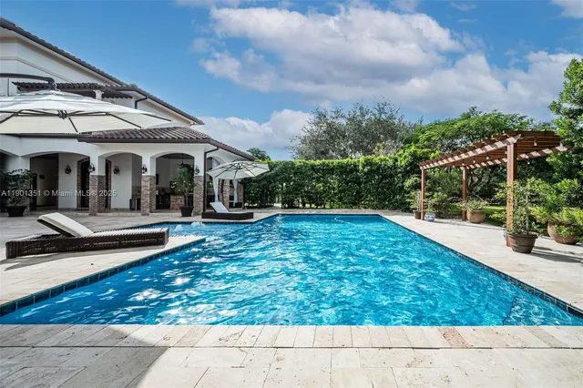 a kitchen with stainless steel appliances kitchen island granite countertop a table and chairs in it