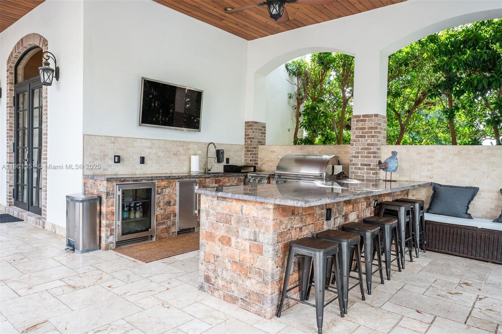 18951 Southwest 53rd Street Southwest Ranches, FL 33332 - Photo 16 of 57 a kitchen with stainless steel appliances kitchen island granite countertop a table and chairs in it
