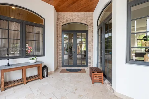 a living room with furniture and painting on the wall