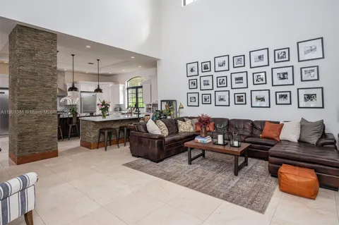 a kitchen with stainless steel appliances kitchen island granite countertop a table chairs in it and wooden floors