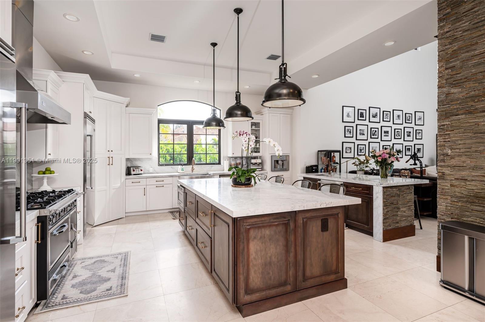 18951 Southwest 53rd Street Southwest Ranches, FL 33332 - Photo 21 of 57 a kitchen with a stove kitchen island a sink stove and refrigerator