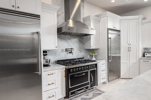 a stove top oven sitting inside of a kitchen