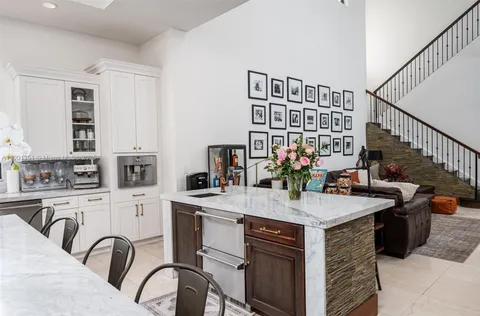 a dining room with furniture a chandelier and wooden floor