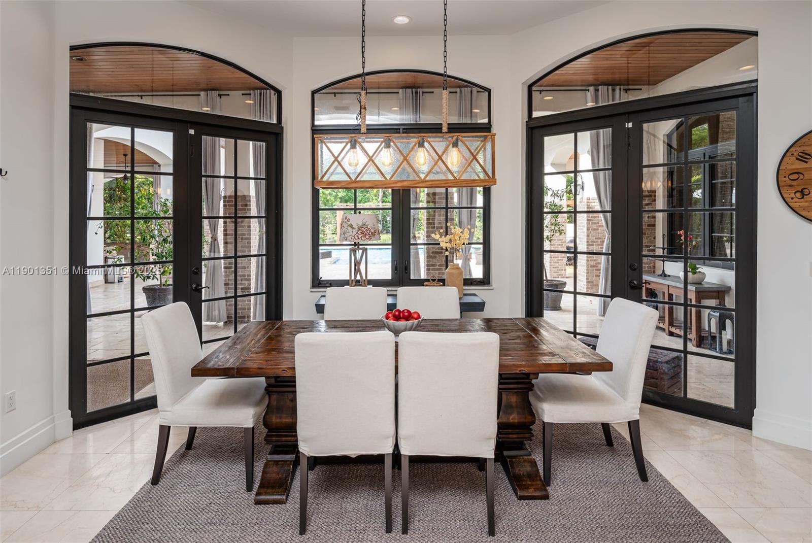 18951 Southwest 53rd Street Southwest Ranches, FL 33332 - Photo 26 of 57 a dining room with furniture a chandelier and wooden floor
