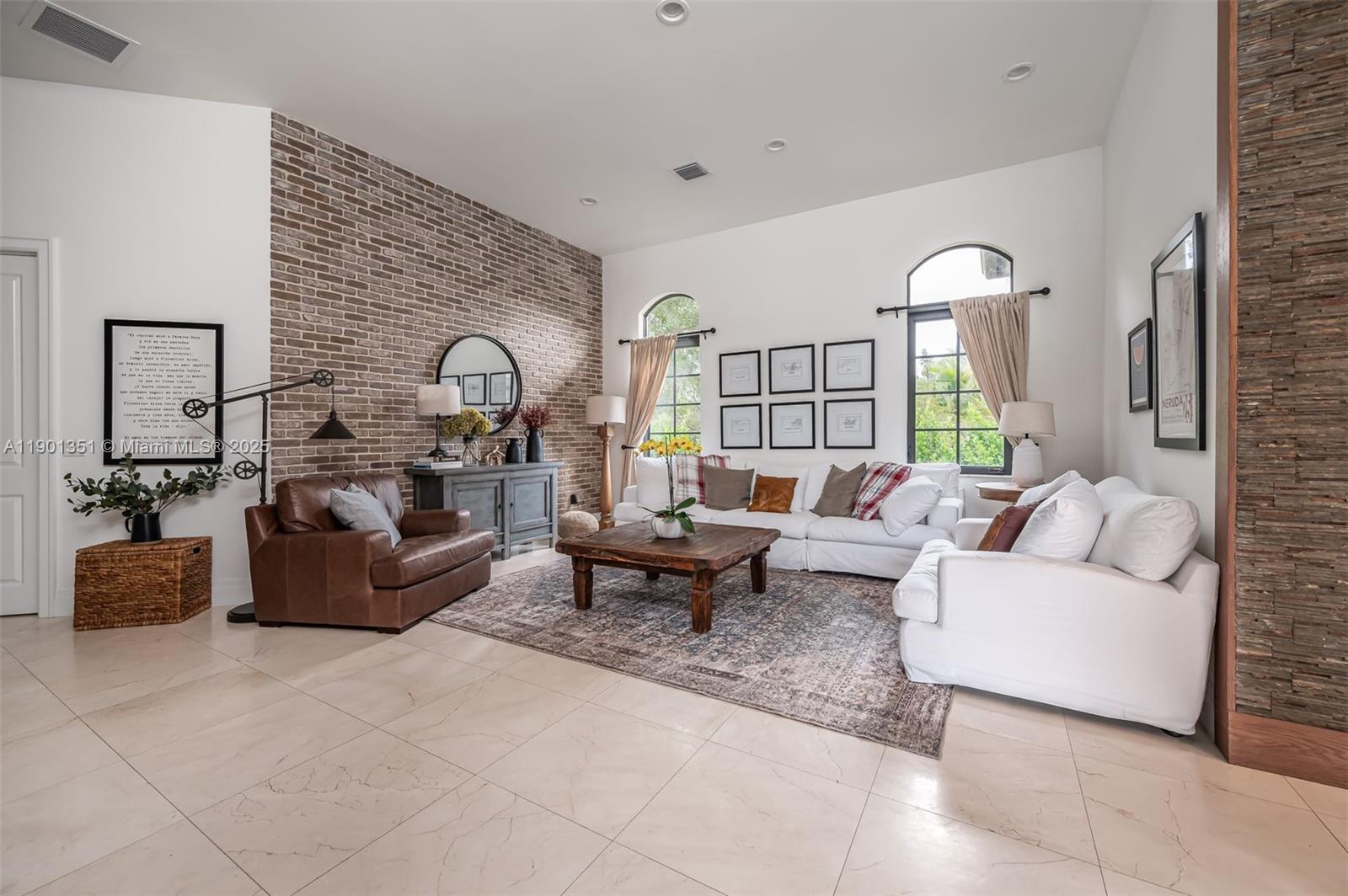 18951 Southwest 53rd Street Southwest Ranches, FL 33332 - Photo 27 of 57 a living room with furniture and a fireplace