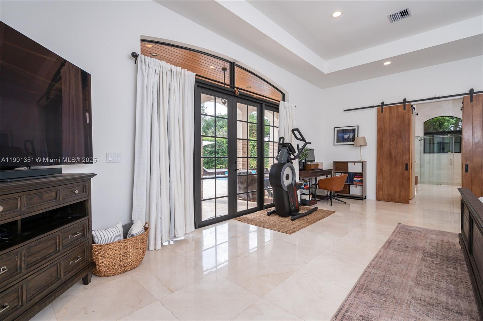 18951 Southwest 53rd Street Southwest Ranches, FL 33332 - Photo 29 of 57 a living room with furniture and a flat screen tv