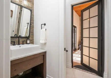 a bathroom with a glass shower door