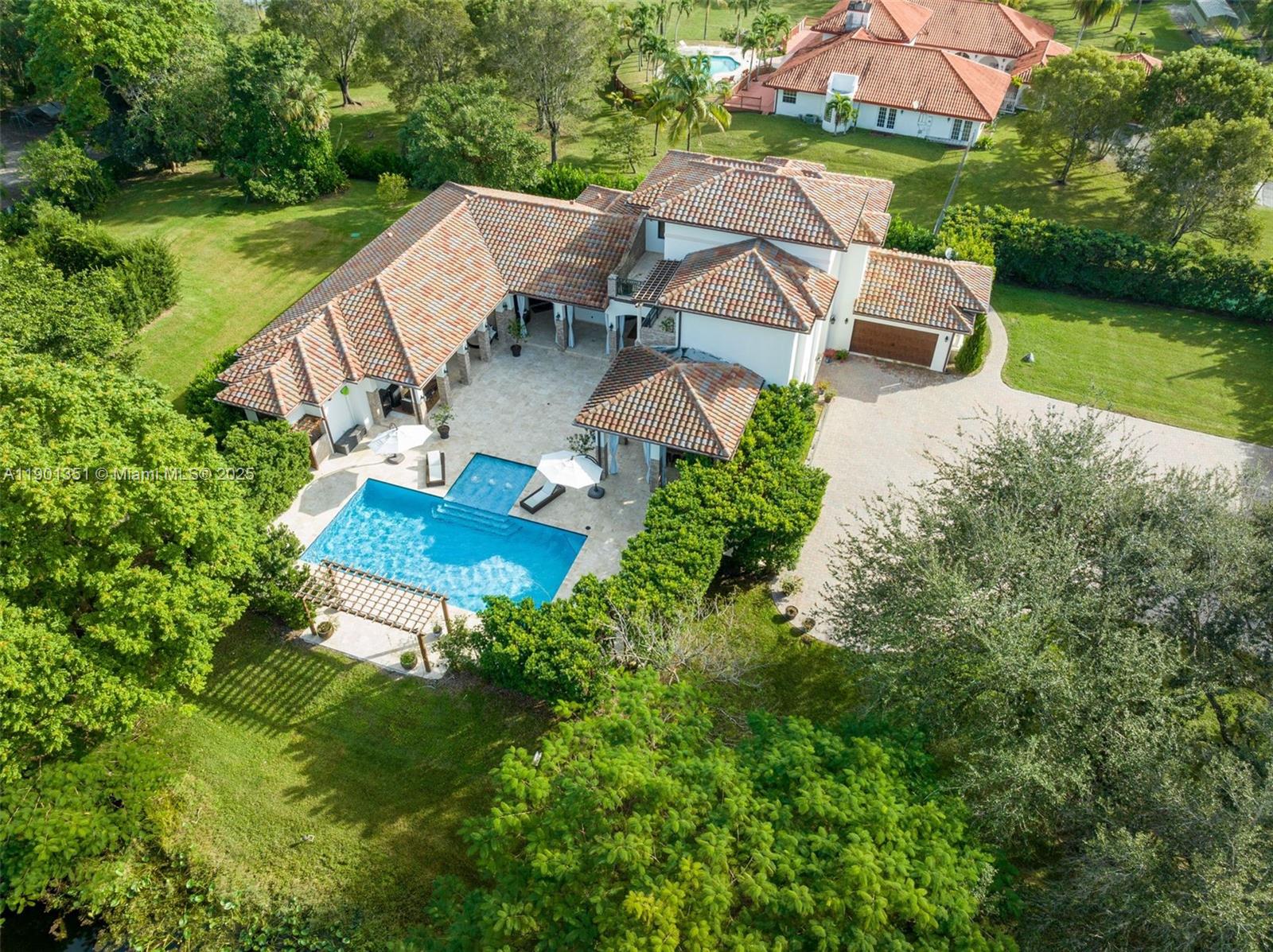 18951 Southwest 53rd Street Southwest Ranches, FL 33332 - Photo 50 of 57 an aerial view of a house with outdoor space patio and lake view