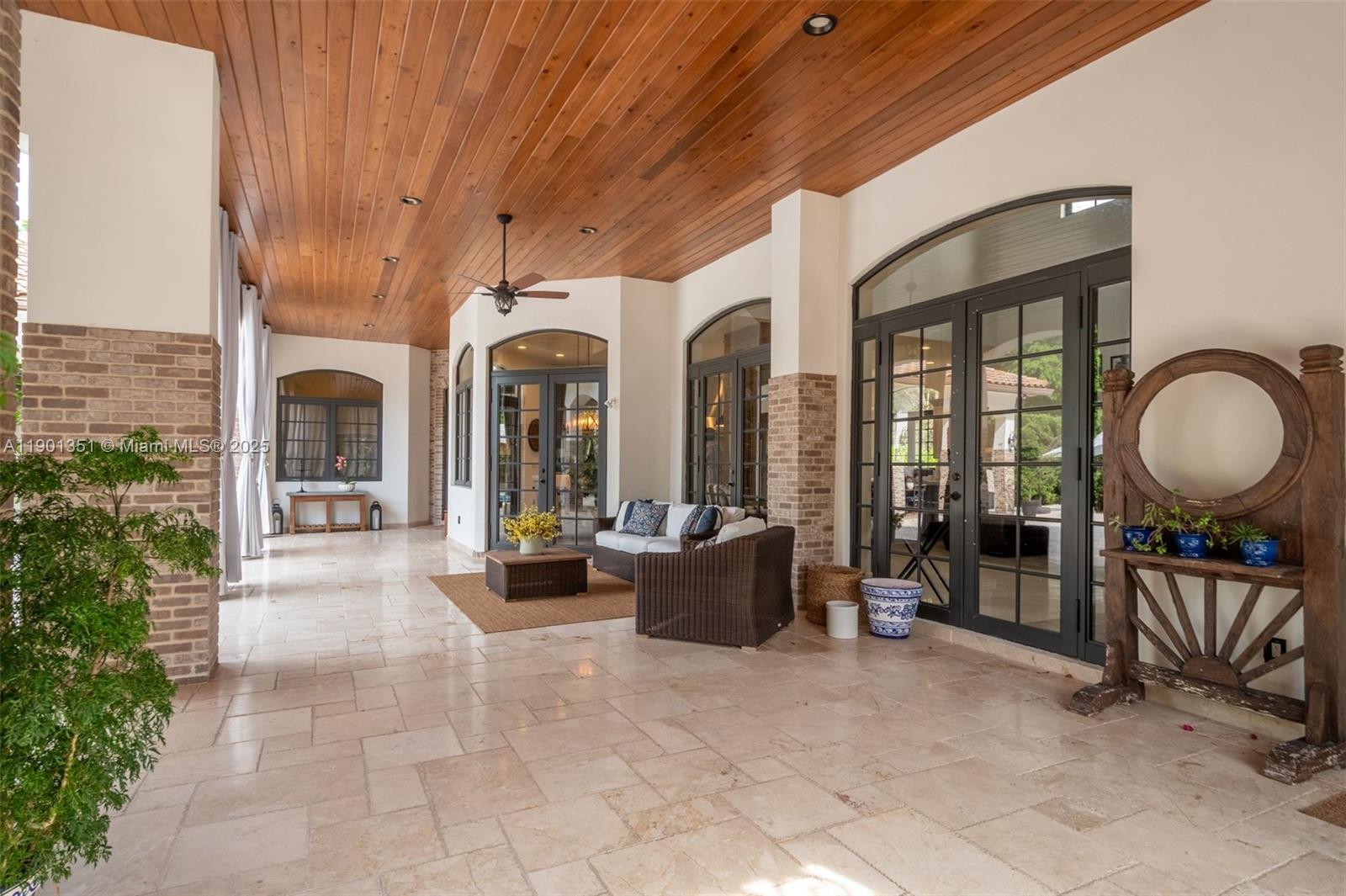 18951 Southwest 53rd Street Southwest Ranches, FL 33332 - Photo 9 of 57 a living room with furniture a chandelier and a large window