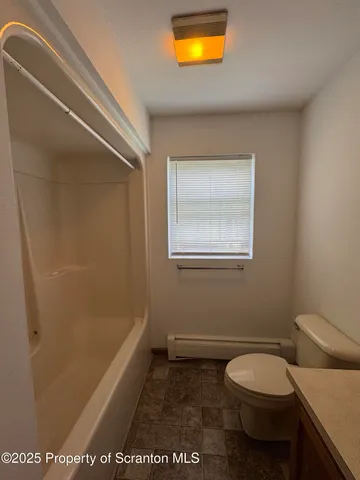 a bathroom with a toilet a sink and a bathtub