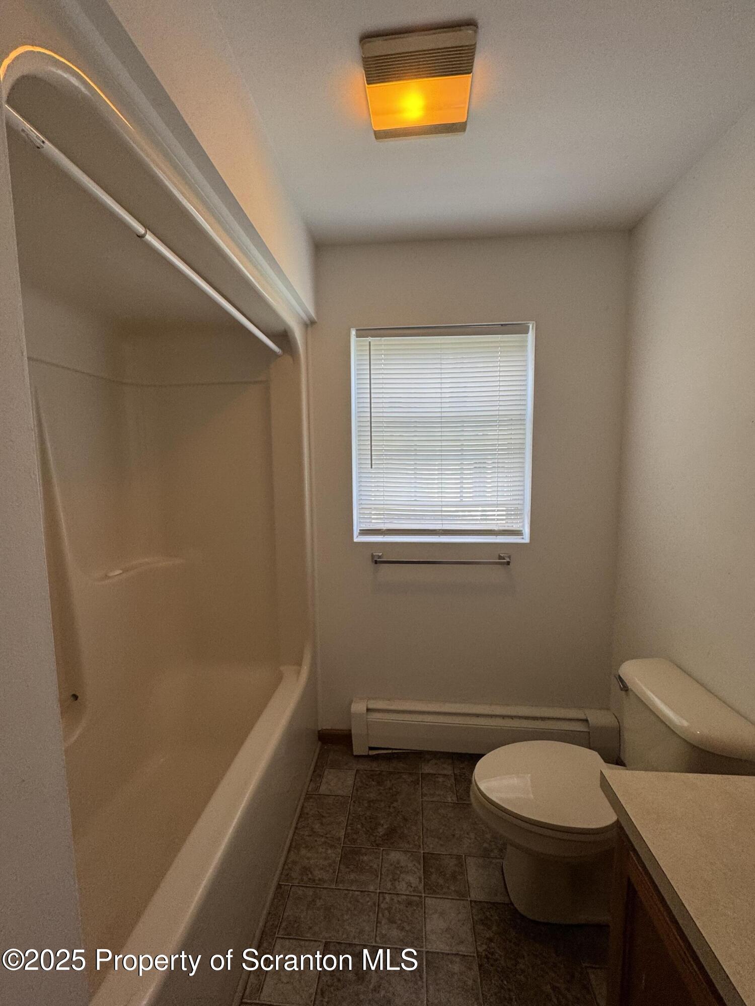 622 Terrace Street, Unit 1R Dunmore, PA 18512 - Photo 12 of 17 a bathroom with a toilet a sink and a bathtub