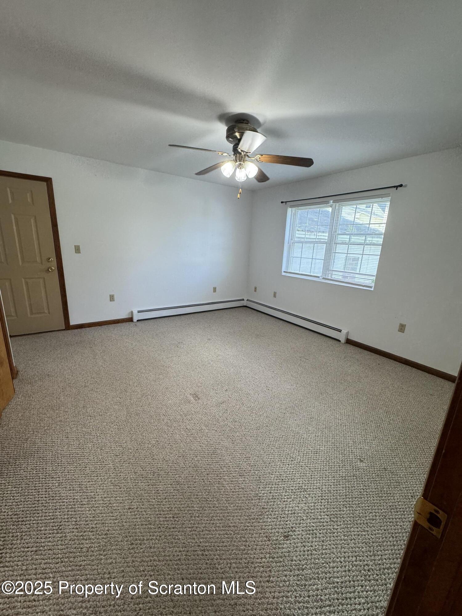 622 Terrace Street, Unit 1R Dunmore, PA 18512 - Photo 16 of 17 an empty room with windows and fan
