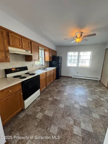 a kitchen with stainless steel appliances granite countertop a stove a sink and a refrigerator