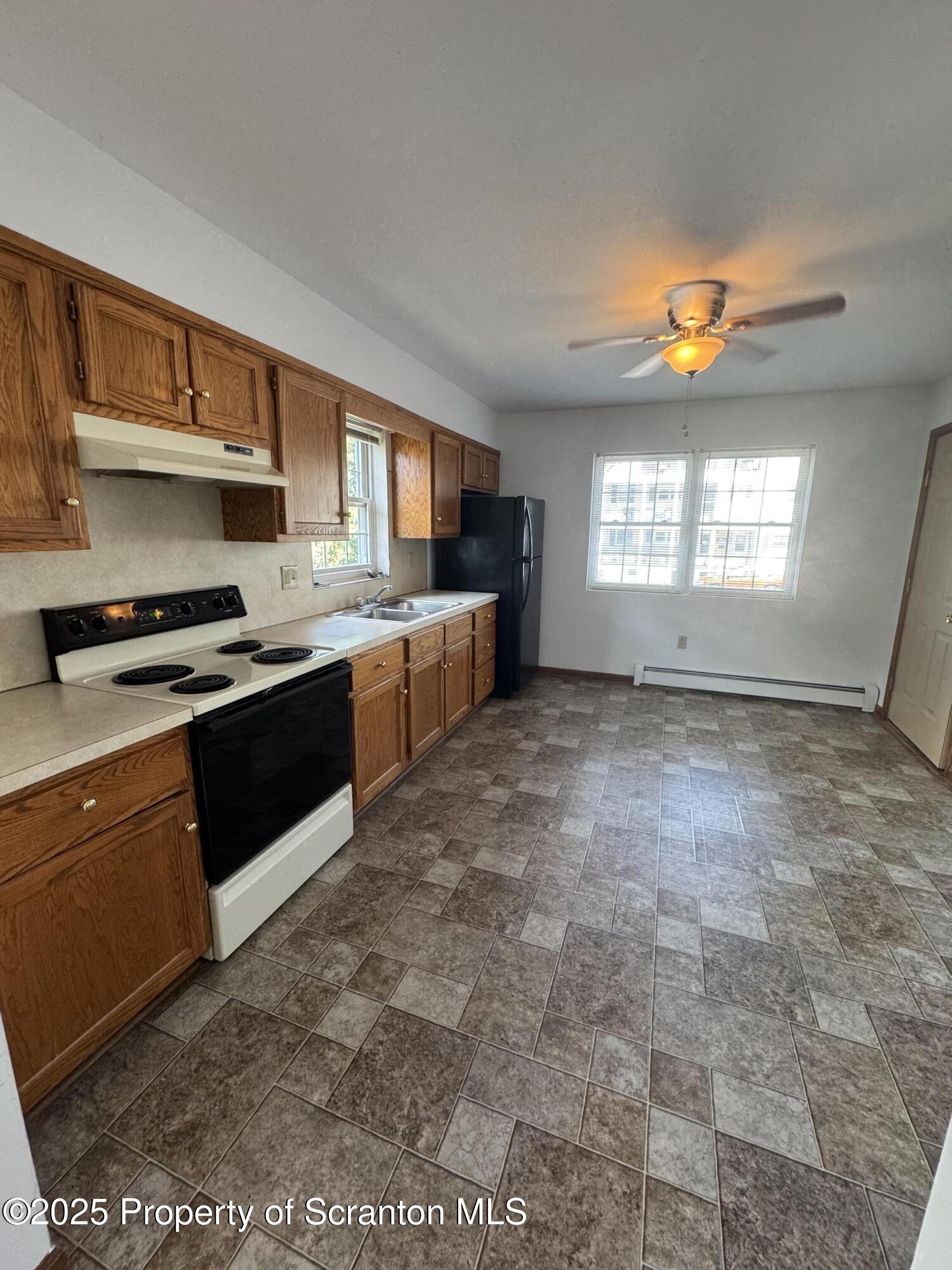 622 Terrace Street, Unit 1R Dunmore, PA 18512 - Photo 5 of 17 a kitchen with stainless steel appliances granite countertop a stove a sink and a refrigerator