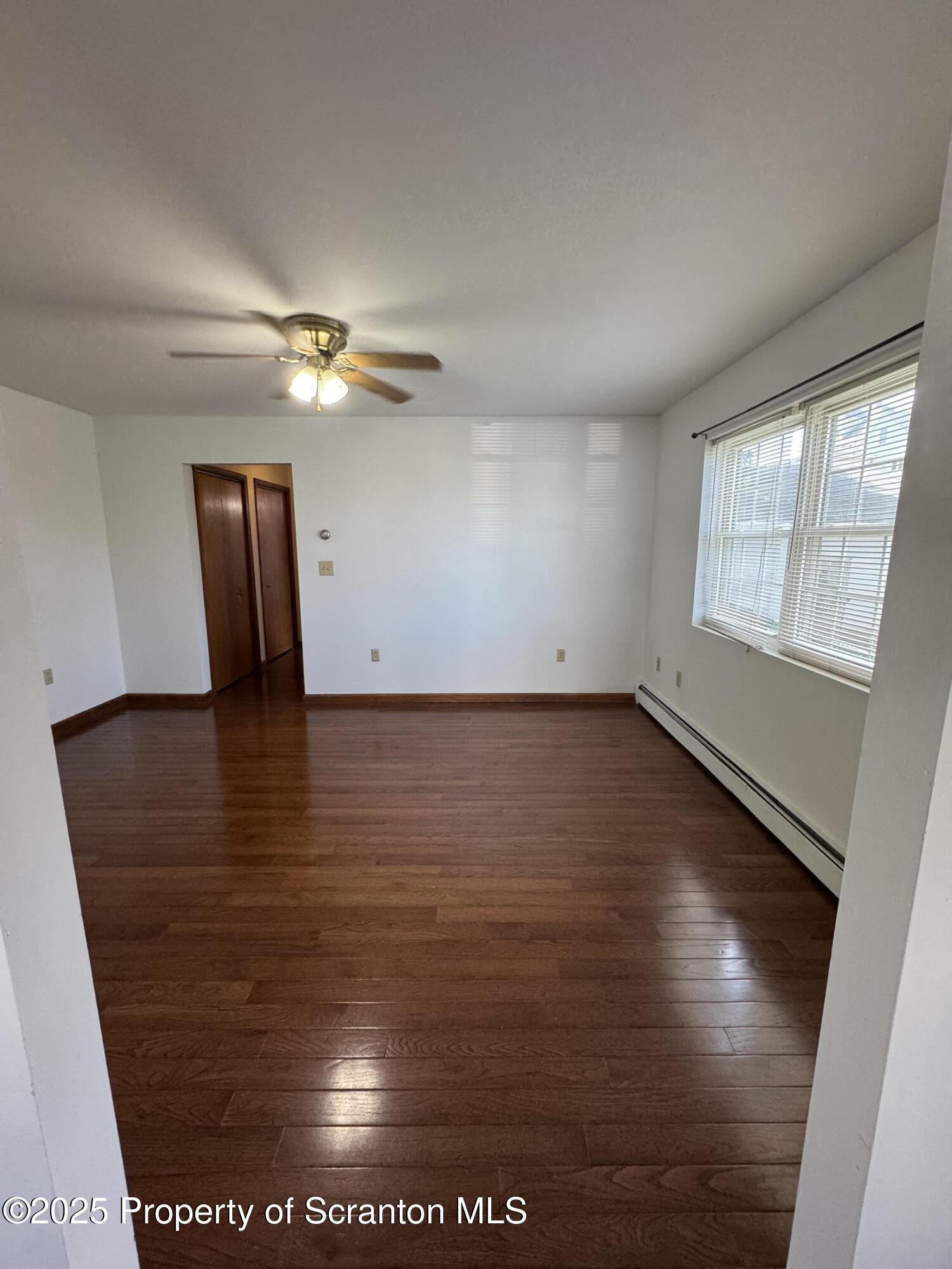 622 Terrace Street, Unit 1R Dunmore, PA 18512 - Photo 9 of 17 an empty room with wooden floor and windows