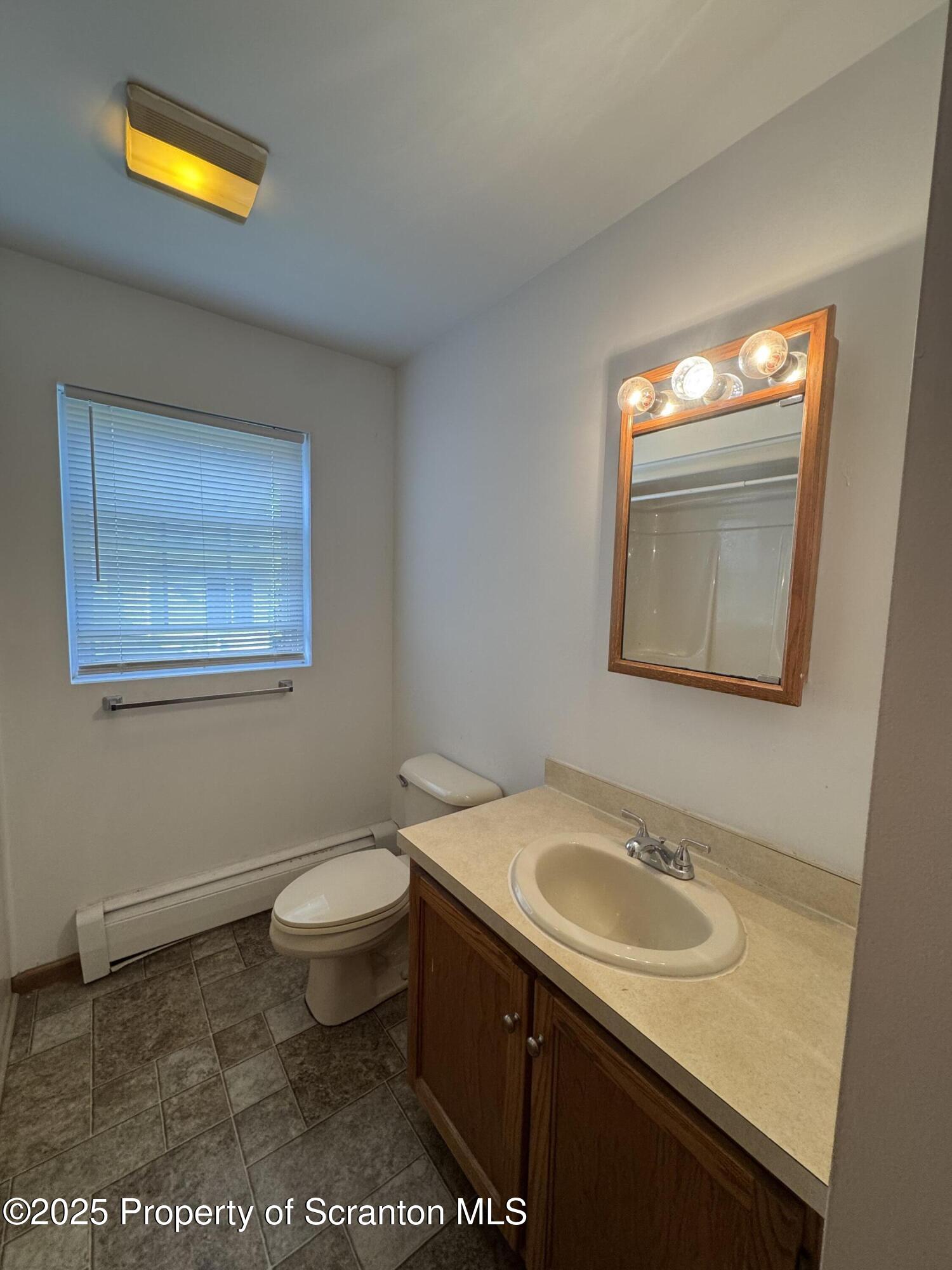 622 Terrace Street, Unit 1R Dunmore, PA 18512 - Photo 10 of 17 a bathroom with a sink toilet and a window