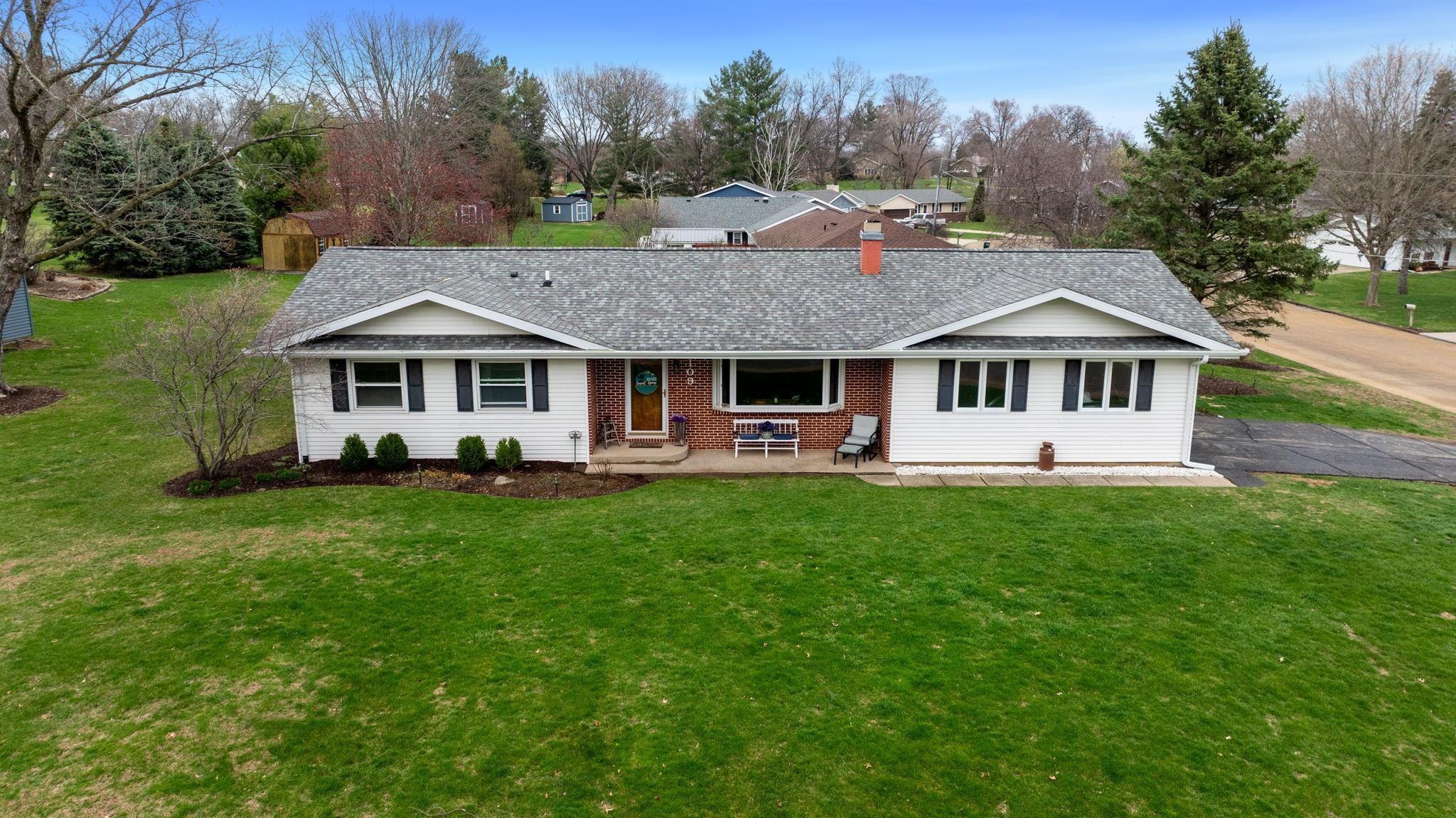 a front view of a house with a yard table and chairs
