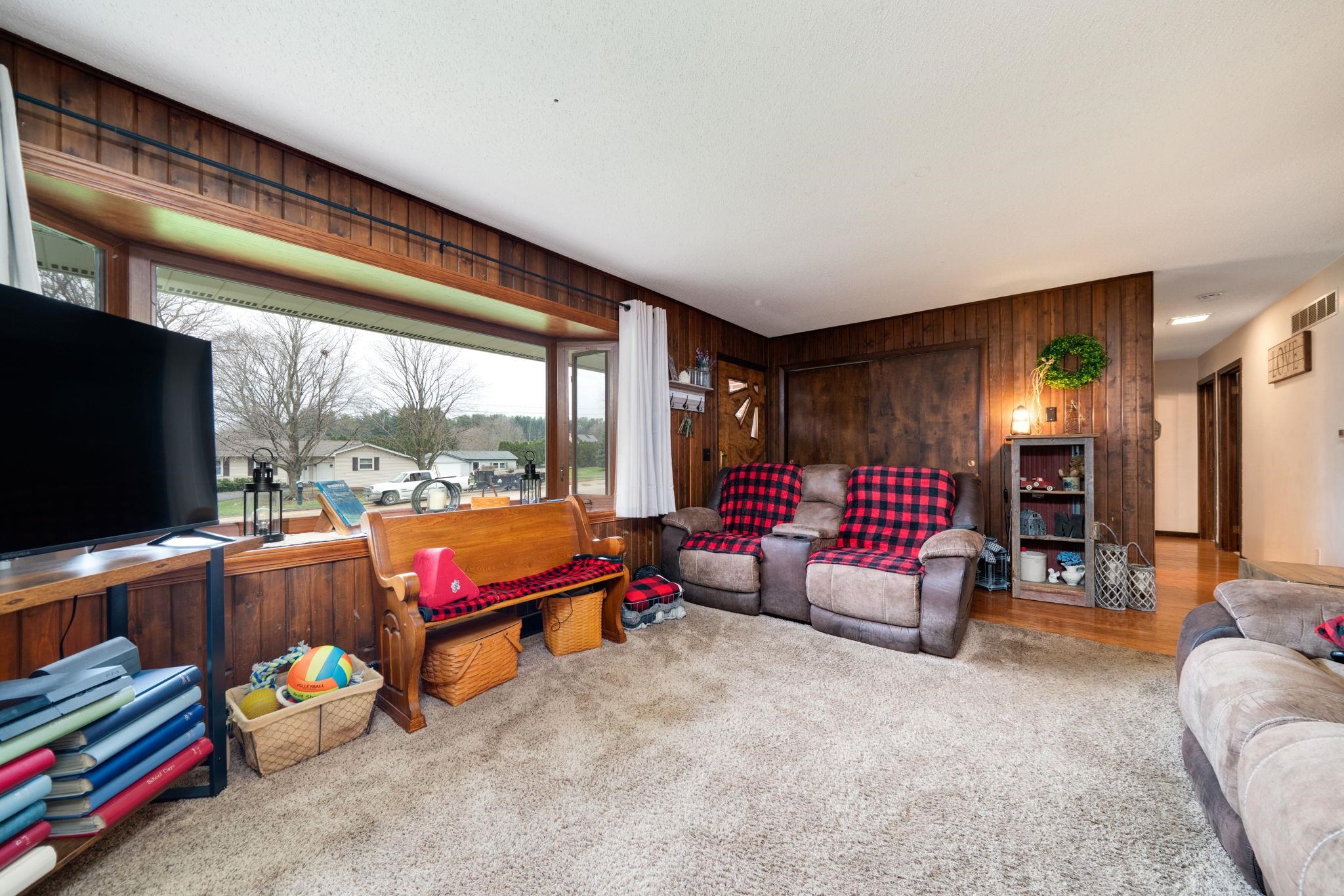 109 13th Street Oregon, IL 61061 - Photo 13 of 44 a living room with furniture a flat screen tv and a large window
