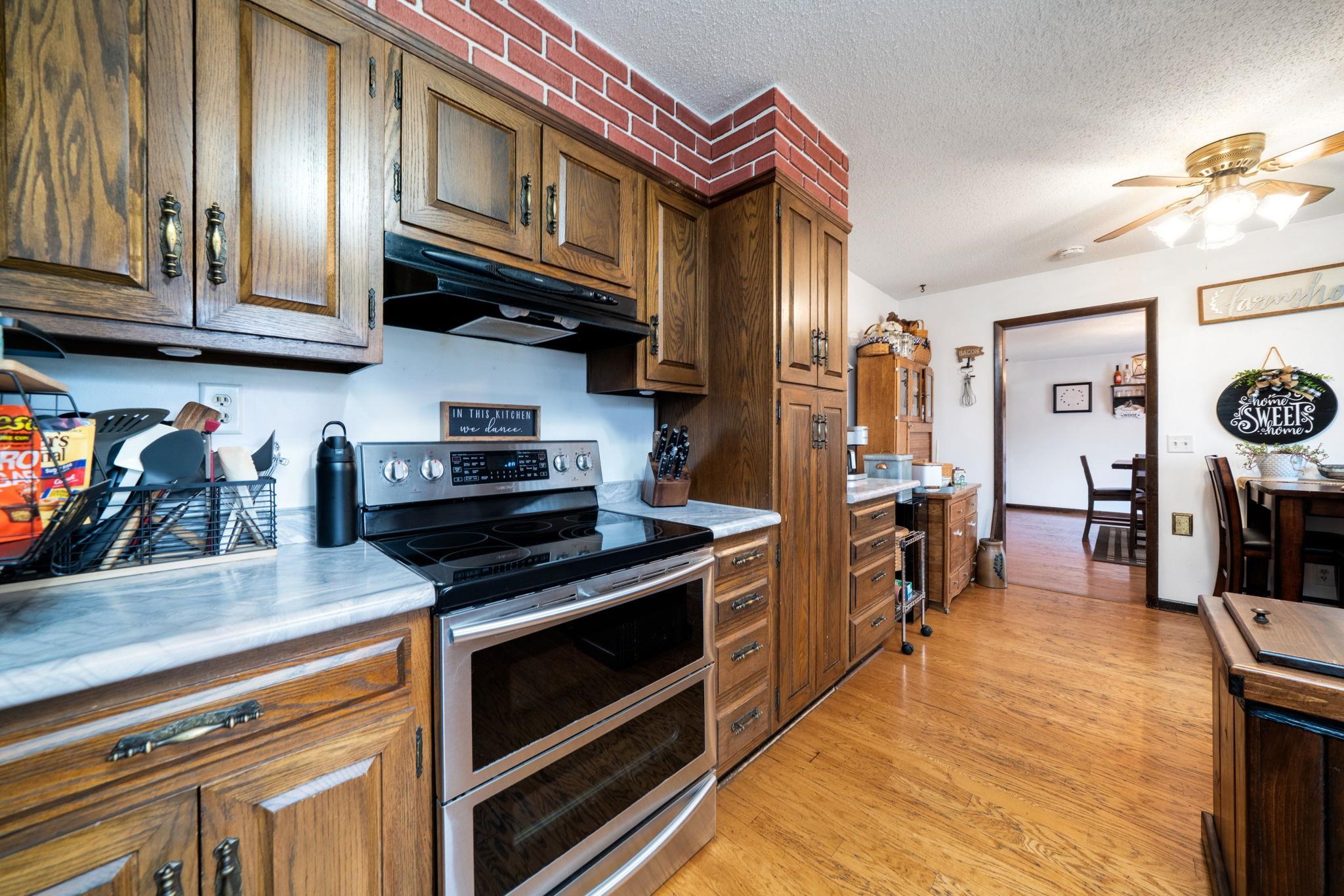 109 13th Street Oregon, IL 61061 - Photo 16 of 44 a kitchen with stainless steel appliances granite countertop a stove and cabinets