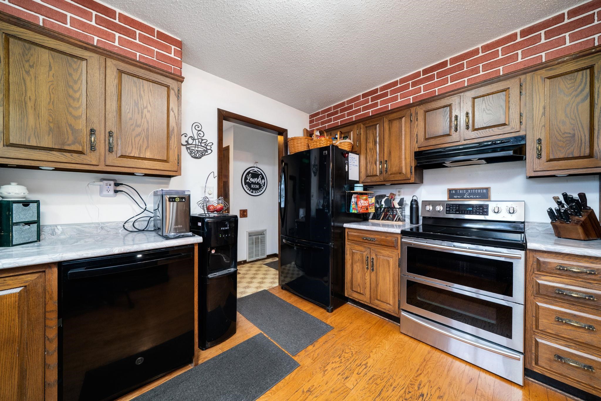 109 13th Street Oregon, IL 61061 - Photo 18 of 44 a kitchen with stainless steel appliances granite countertop a stove and a refrigerator
